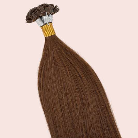 Brown keratin tip hair extensions on a white background