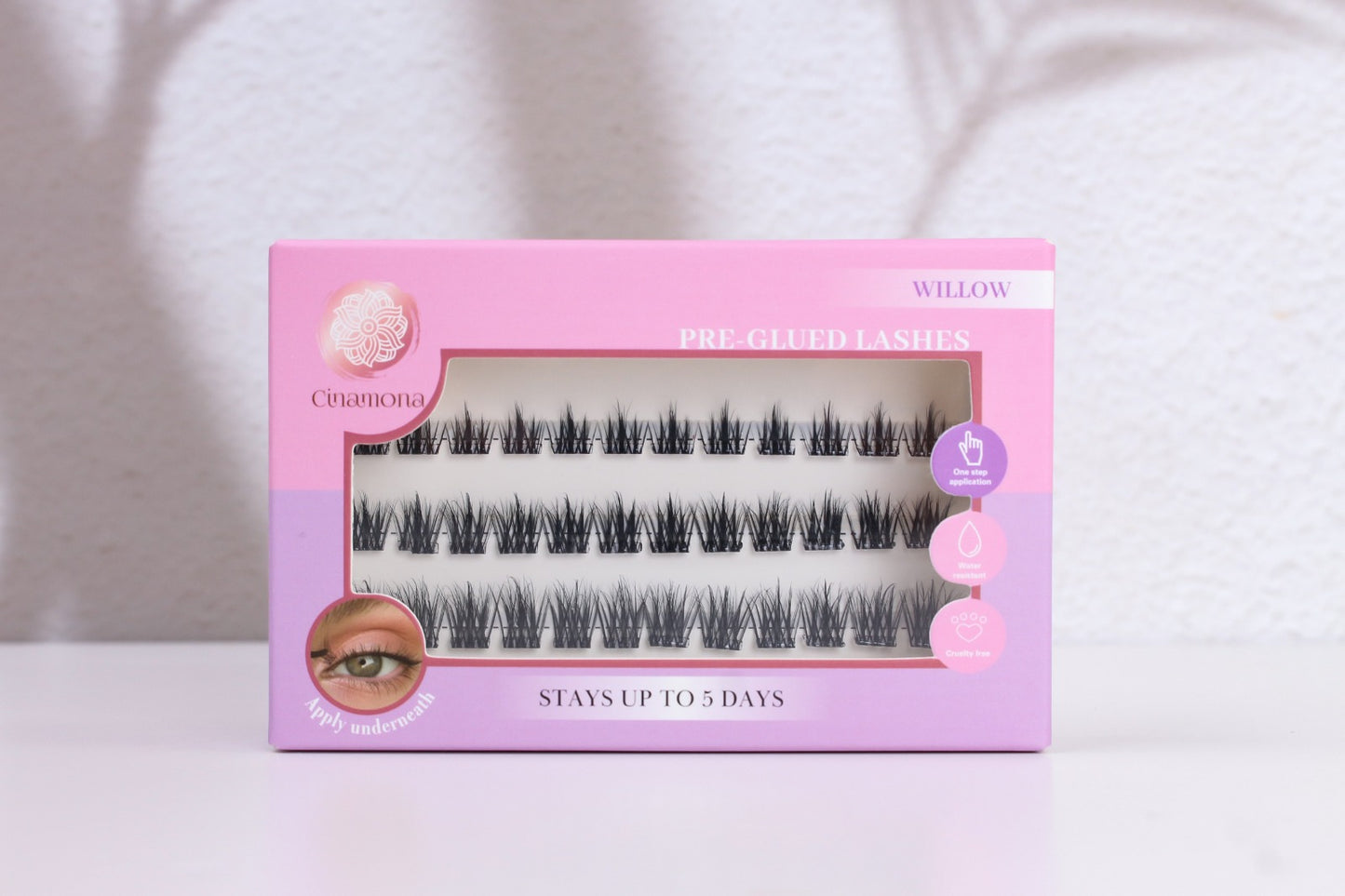 Pink and purple box of false eyelashes on a white background